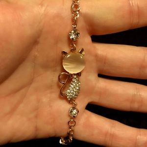 Cat bracelet that is gold tone.